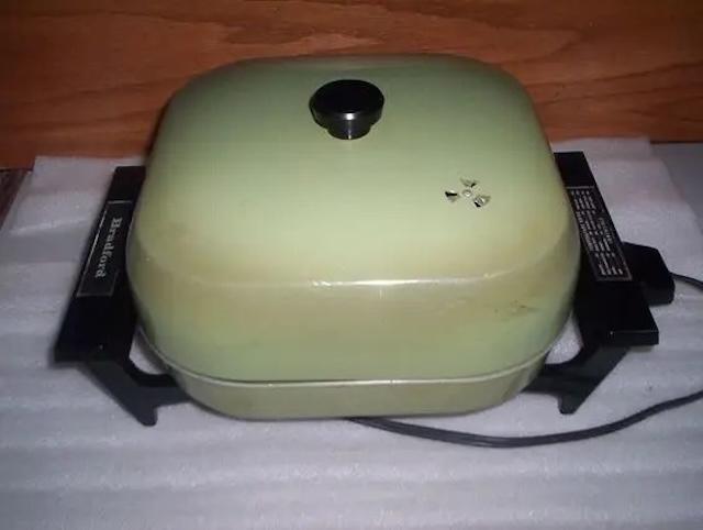 A classic vintage electric skillet with its iconic pale green design. The compact yet versatile kitchen tool that made cooking convenient and efficient in the past